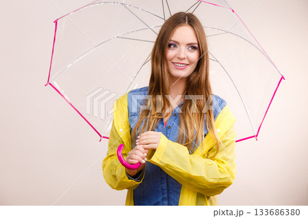 Woman wearing waterproof coat under umbrella 133686380