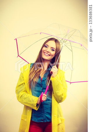 Woman wearing waterproof coat under umbrella 133686381