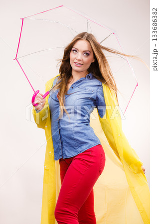 Woman wearing waterproof coat under umbrella 133686382