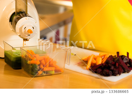 Make vegetables juice in juicer machine Make vegetables juice in juicer machine 133686665