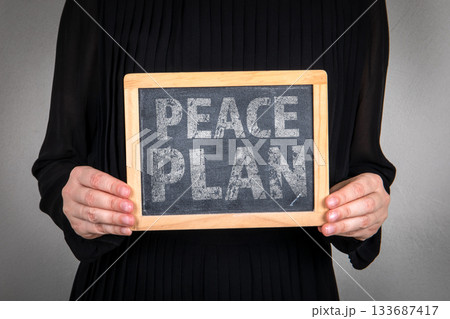 Peace Plan. Person Holding Chalkboard in a Neutral Setting 133687417