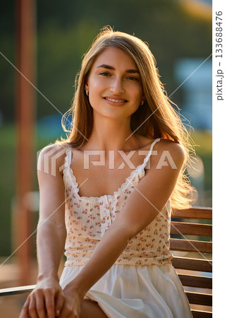 Slavic Woman in White Dress at Golden Hour 133688476