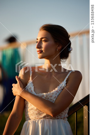 Slavic Woman in White Lace Dress at Sunset 133688498