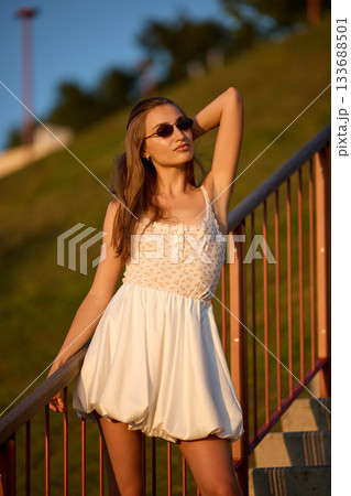 Slavic Woman in White Dress on Staircase Slavic Woman in White Dress on Staircase 133688501