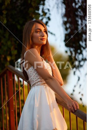 Slavic Woman in White Dress on Staircase 133688508