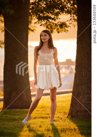 Slavic Woman in White Dress at Sunset Slavic Woman in White Dress at Sunset 133688509