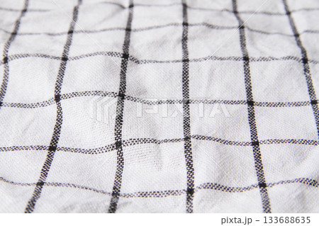 Plaid material. Towel on the table. Wrinkled fabric with stripes. 133688635