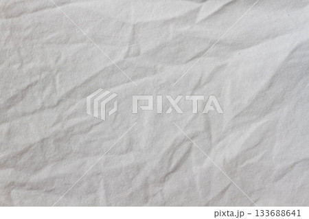 Wrinkled sheet. White fabric close-up. Burlap texture. Sheet on the bed. Wrinkled sheet. White fabric close-up. Burlap texture. Sheet on the bed. 133688641