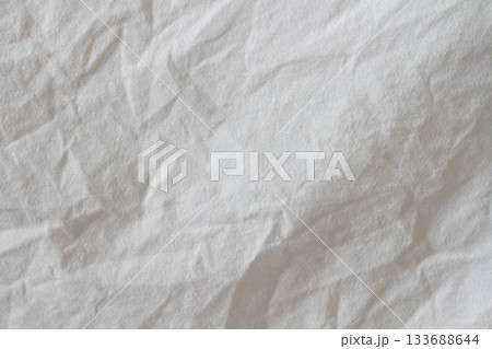Wrinkled sheet. White fabric close-up. Burlap texture. Sheet on the bed. 133688644