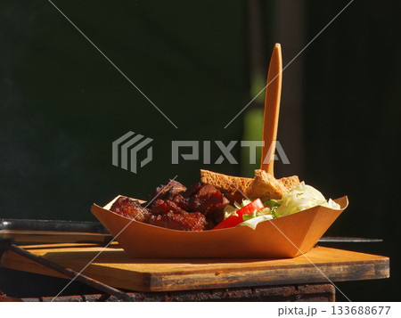 Street food meal served in paper tray 133688677