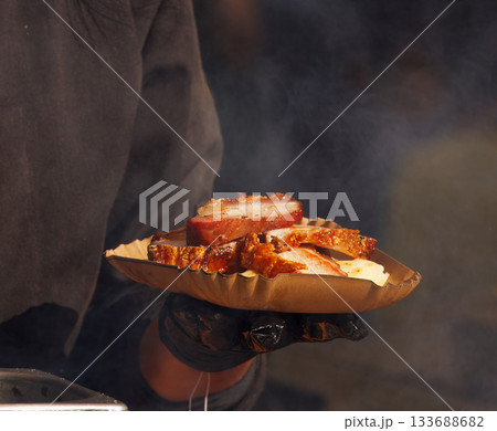 Smoked pork belly served on a paper tray 133688682