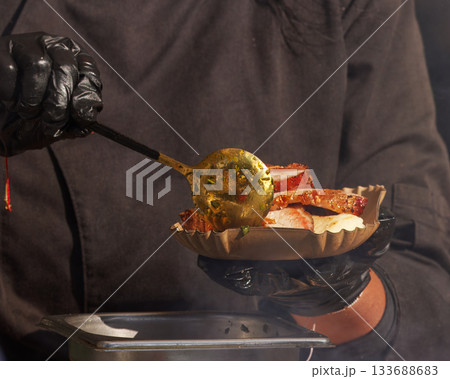 Chef serving grilled meat at street food festival 133688683