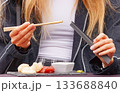 Young woman eating seafood at farmers market 133688840