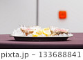 Fresh oysters on ice with lemon slices 133688841