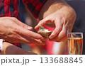 Man holding fresh oyster with glass of sparkling wine 133688845