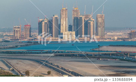 Construction of new skyscrapers in Dubai Creek Harbor aerial timelapse. Dubai - UAE. Construction of new skyscrapers in Dubai Creek Harbor aerial timelapse. Dubai - UAE. 133688894