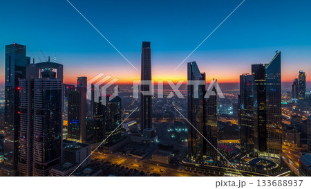 Dubai downtown skyline with tallest skyscrapers and traffic on highway night to day timelapse Dubai downtown skyline with tallest skyscrapers and traffic on highway night to day timelapse 133688937
