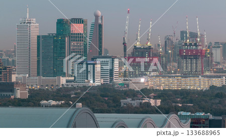 Aerial cityscape with architecture of Dubai downtown night to day timelapse, United Arab Emirates. Aerial cityscape with architecture of Dubai downtown night to day timelapse, United Arab Emirates. 133688965