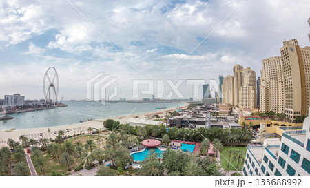 Aerial view of beach and tourists walking and sunbathing on holiday in JBR timelapse in Dubai, UAE 133688992