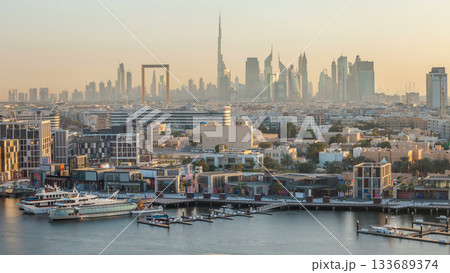 Dubai creek landscape timelapse with waterfront and modern buildings in the background during sunset 133689374