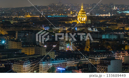 Aerial panorama above houses rooftops in a Paris night timelapse 133689449