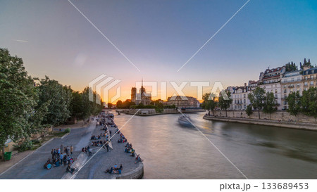 Rear view of Notre Dame De Paris cathedral at sunset with sun in the frame timelapse. Rear view of Notre Dame De Paris cathedral at sunset with sun in the frame timelapse. 133689453