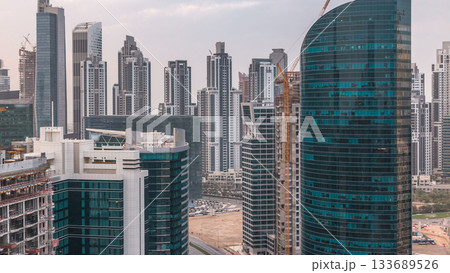 Dubai business bay towers at sunset aerial timelapse. Dubai business bay towers at sunset aerial timelapse. 133689526