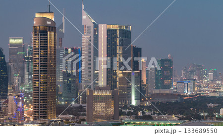 Dubai Downtown day to night timelapse. Aerial view over big futuristic city by night. Dubai Downtown day to night timelapse. Aerial view over big futuristic city by night. 133689550