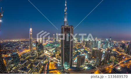 Dubai Downtown day to night timelapse modern towers panoramic view from the top in Dubai, United Arab Emirates. Dubai Downtown day to night timelapse modern towers panoramic view from the top in Dubai, United Arab Emirates. 133689570