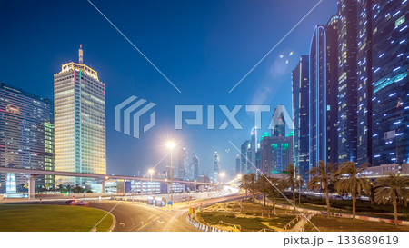 Traffic on intersection and bridge at the Sheikh Zayed Road day to night timelapse 133689619