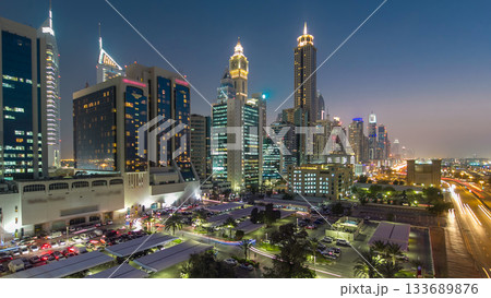 Downtown Dubai towers day to night timelapse. Aerial view of Sheikh Zayed road with skyscrapers after sunset. Downtown Dubai towers day to night timelapse. Aerial view of Sheikh Zayed road with skyscrapers after sunset. 133689876