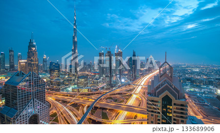 Modern skyscrapers and busy evening highways day to night timelapse in luxury Dubai city, Dubai, United Arab Emirates 133689906