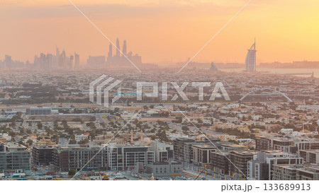 Dubai skyline with Dubai Marina skyscrapers and coastline at sunset timelapse with seven star luxury hotel in Dubai, UAE. Dubai skyline with Dubai Marina skyscrapers and coastline at sunset timelapse with seven star luxury hotel in Dubai, UAE. 133689913