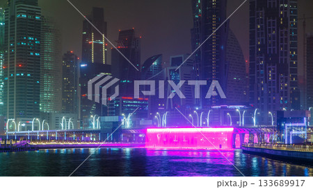 Illuminated Waterfall at the Sheikh Zayed Bridge timelapse, part of the Dubai Water Canal. Dubai, United Arab Emirates, Middle East 133689917
