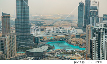 Aerial view of Dubai downtown Lake area timelapse and skyscrapers of Old Town Island, from top. Skyline urban city of Dubai. 133689919