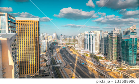 Aerial view of Dubai marina skyscrapers and Jumeirah lakes towers timelapse with traffic on sheikh zayed road. 133689980