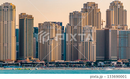 Jumeirah Beach Residence as seen from the palm jumeirah with sea timelapse. Dubai, United Arab Emirates 133690001
