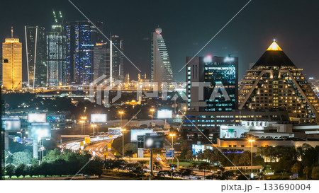 Dubai downtown skyline timelapse at night. Rooftop view of Sheikh Zayed road with numerous illuminated towers. 133690004