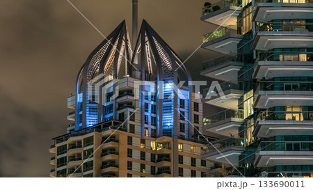 Close up view of Dubai Marina tallest towers in Dubai at night timelapse Close up view of Dubai Marina tallest towers in Dubai at night timelapse 133690011