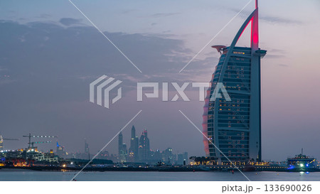 Dubai skyline with Burj Al Arab hotel day to night timelapse. 133690026