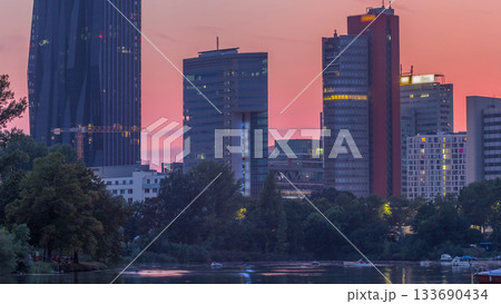 Vienna international center skyscrapers with Kaiserwasser lake reflection view day to night timelapse 133690434