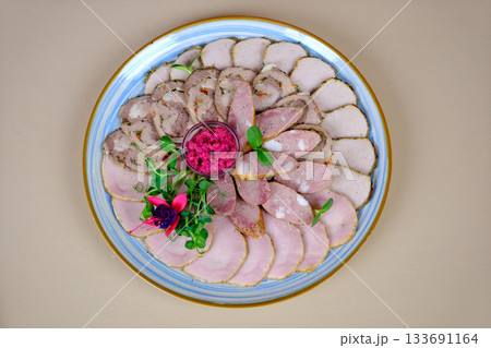 Meat platter garnish table sits a delightful plate filled with delicious food, featuring tender meat generously coated in rich sauce 133691164