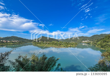 Reflections on Qingtan Weir Lake Surrounded by Mountains in Xindian Taiwan. 133693095