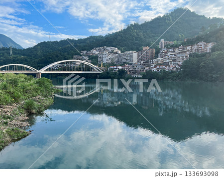 Swallow Lake with Arch Bridge and Riverside Town in Xindian Taiwan. Swallow Lake with Arch Bridge and Riverside Town in Xindian Taiwan. 133693098