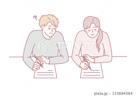 Boy cheating on school exam 133694364