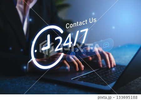 Customer service support concept showing 24/7 contact availability with a business professional using laptop for communication via email, chat, or call, symbolizing reliability. 133695188