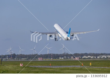Passenger airplane taking off near wind turbines in Vijfhuizen 133695912