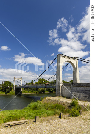 Suspension bridge spanning Loire river in Chalonnes sur Loire, France Suspension bridge spanning Loire river in Chalonnes sur Loire, France 133695932
