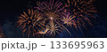 Colorful fireworks explode over the city skyline at night, celebrating the arrival of 2026 with joy, light, and new energy. 133695963
