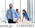 construction engineer manager stand and holding white hardhat in front of engineers team meeting for architectural project in the office construction site 133695965
